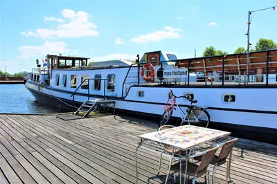 a bike parked on a dock next to a boat at Mps Holland in Amsterdam