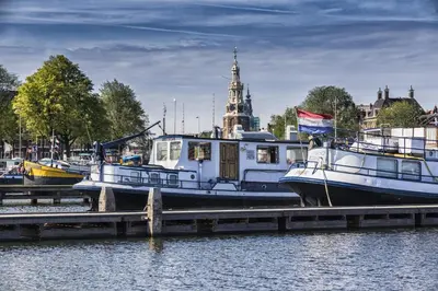 a group of boats docked at a dock at Mps Holland in Amsterdam