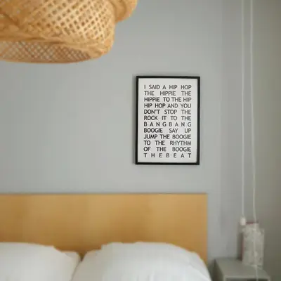 a bedroom with a bed and a calendar on the wall at Sonnevanck Wijk aan Zee in Wijk aan Zee