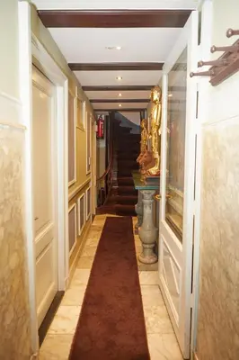 a hallway with a long carpet in a building at Redlightdistrict chinacitycentre partypalace in Amsterdam