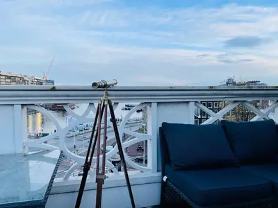 a camera and a couch on a balcony with a bridge at Redlightdistrict chinacitycentre partypalace in Amsterdam