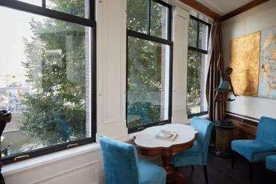 a room with windows and a table and chairs at Redlightdistrict chinacitycentre partypalace in Amsterdam