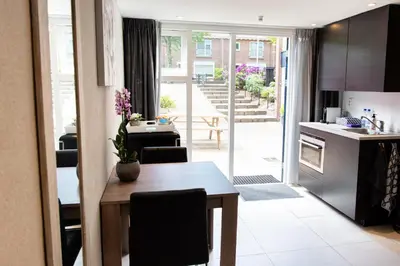 a kitchen and dining room with a table and a kitchen and a dining room at Studio Excellent 21 in Soesterberg