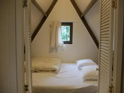 a bedroom with two beds and a window at Pelt 35 in Bergen