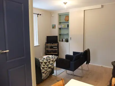 a living room with two chairs and a mirror at Pelt 35 in Bergen