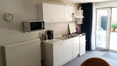 a small kitchen with a sink and a microwave at Appartement in Zandvoort in Zandvoort