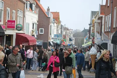 a crowd of people walking down a busy city street at Appartement in Zandvoort in Zandvoort