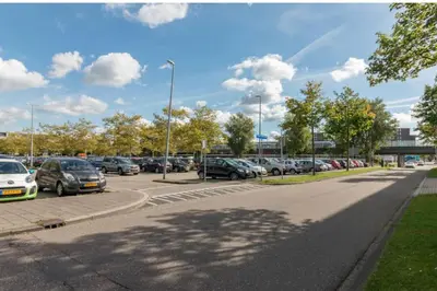 a parking lot with a lot of cars parked at Family house next to train and close to Amsterdam and Schiphol in Almere