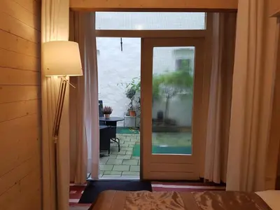 a bedroom with a door leading to a patio at B&B Wladimir Studios in Amsterdam