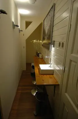 a bathroom with a sink and a wooden counter at B&B Wladimir Studios in Amsterdam