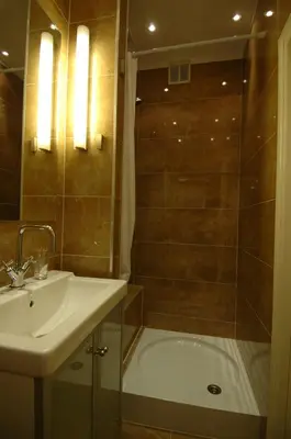 a bathroom with a shower and a sink and a tub at B&B Wladimir Studios in Amsterdam