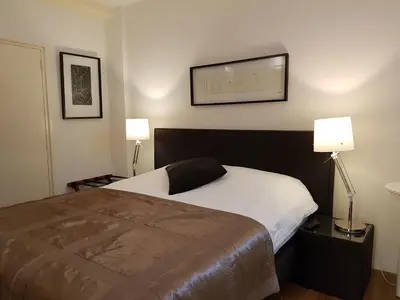 a bedroom with a bed and two lamps on the wall at B&B Wladimir Studios in Amsterdam