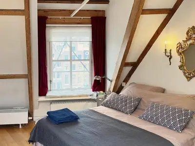 a bedroom with a bed and a window at Canal View B&B Amsterdam in Amsterdam