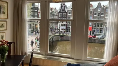 a room with a window with a view of a canal at Canal View B&B Amsterdam in Amsterdam