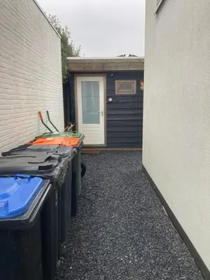 a row of trash cans sitting next to a building at Bed & Breakfast ‘t Westergouwertje in Gouda