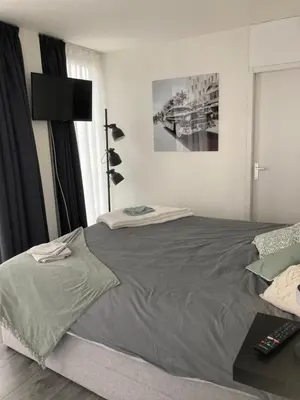 a bedroom with a large bed in a room at Bed & Breakfast ‘t Westergouwertje in Gouda