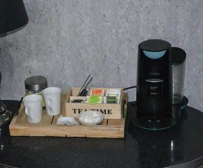 a tray with a coffee maker and cups on a counter at Bed & Breakfast ‘t Westergouwertje in Gouda