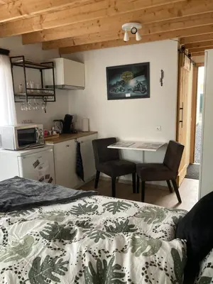 a bedroom with a bed and a table and chairs at Bed & Breakfast ‘t Westergouwertje in Gouda