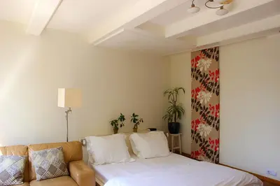 a bedroom with a bed and a couch at Amsterdam Jewel Canal Apartments in Amsterdam