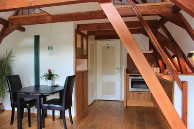 a kitchen and dining room with a table and chairs at Amsterdam Jewel Canal Apartments in Amsterdam