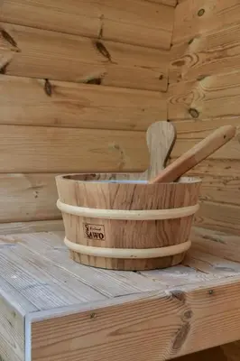 a wooden basket with two wooden baseball bats in it at The Cosy Cottage for Comfort with Sauna and Hottub in Zeewolde