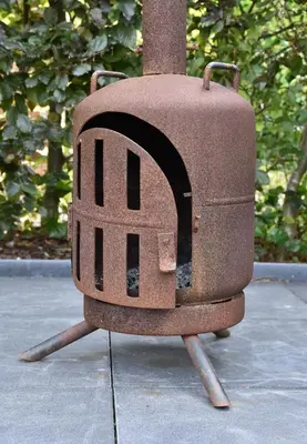 a brick oven sitting on top of a sidewalk at The Cosy Cottage for Comfort with Sauna and Hottub in Zeewolde