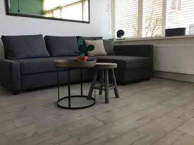 a living room with a couch and a table at Amsterdam Beach Home 4 in Zandvoort