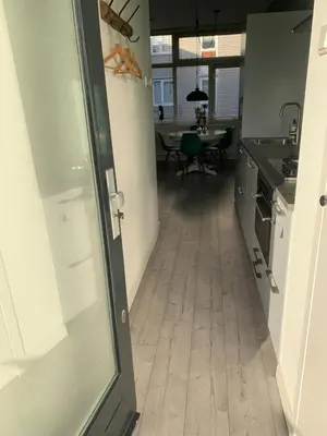 a kitchen with a hallway leading to a dining room at Amsterdam Beach Home 4 in Zandvoort