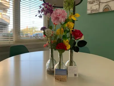 three vases filled with flowers sitting on a table at Amsterdam Beach Home 4 in Zandvoort