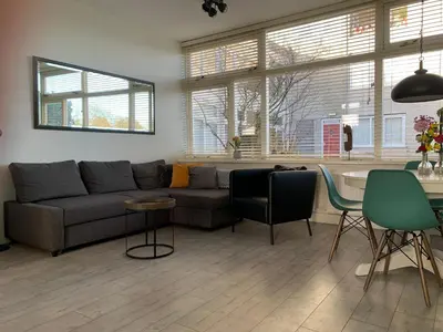 a living room with a couch and a table at Amsterdam Beach Home 4 in Zandvoort