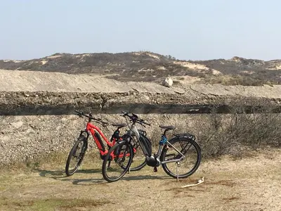 two bikes are parked next to a wall at Amsterdam Beach Home 4 in Zandvoort