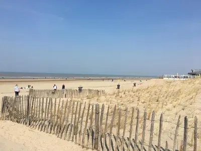 a group of people walking on the beach at Amsterdam Beach Home 4 in Zandvoort