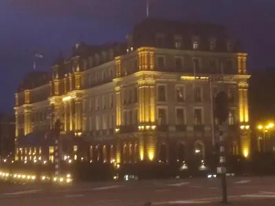 a large white building lit up at night at Houseboat Little Amstel in Amsterdam
