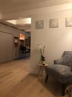 a living room with a chair and a table at Singel Residence in Amsterdam