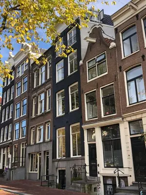 a row of houses on a city street at Singel Residence in Amsterdam