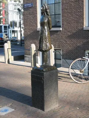 a statue of a woman standing on a trash can at Singel Residence in Amsterdam