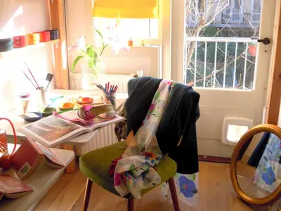 a chair with a blanket on it in a room at MissOrtelia B&B in Amsterdam