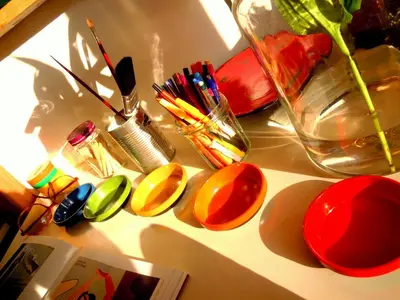 a table with colorful bowls and a vase on it at MissOrtelia B&B in Amsterdam