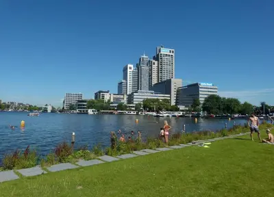 a group of people in a park near a body of water at Houseboat Ark van Amstel in Amsterdam