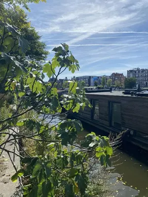 a building next to a body of water at Houseboat Ark van Amstel in Amsterdam