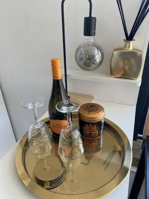 a glass tray with two bottles of wine and glasses at Houseboat Ark van Amstel in Amsterdam