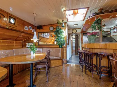 a restaurant with wooden walls and tables and chairs at Boat in Leiden near City Center & Museums in Leiden