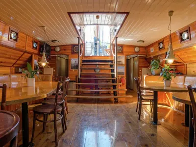 a restaurant with wooden walls and tables and chairs at Boat in Leiden near City Center & Museums in Leiden