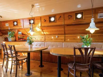 a dining room with wooden walls and two tables and chairs at Boat in Leiden near City Center & Museums in Leiden