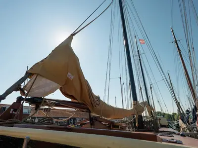 a boat with a sail in a harbor at Boat in Leiden near City Center & Museums in Leiden
