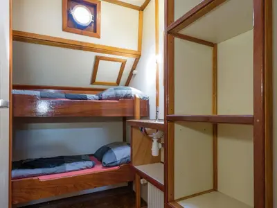 a room with two bunk beds in a house at Boat in Leiden near City Center & Museums in Leiden