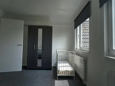 a hallway with a crib in a room with a window at Villa in Zeewolde near Horsterwold Forest in Zeewolde