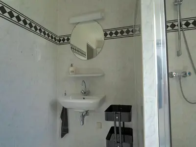 a bathroom with a sink and a mirror and a shower at Villa in Zeewolde near Horsterwold Forest in Zeewolde