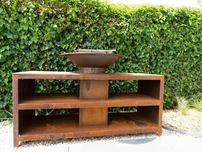 a bird bath sitting on a stand in front of a hedge at Villa in Zeewolde near Horsterwold Forest in Zeewolde