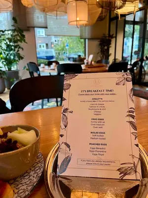 a menu on a table with a bowl of food at Spinoza Suites in Amsterdam